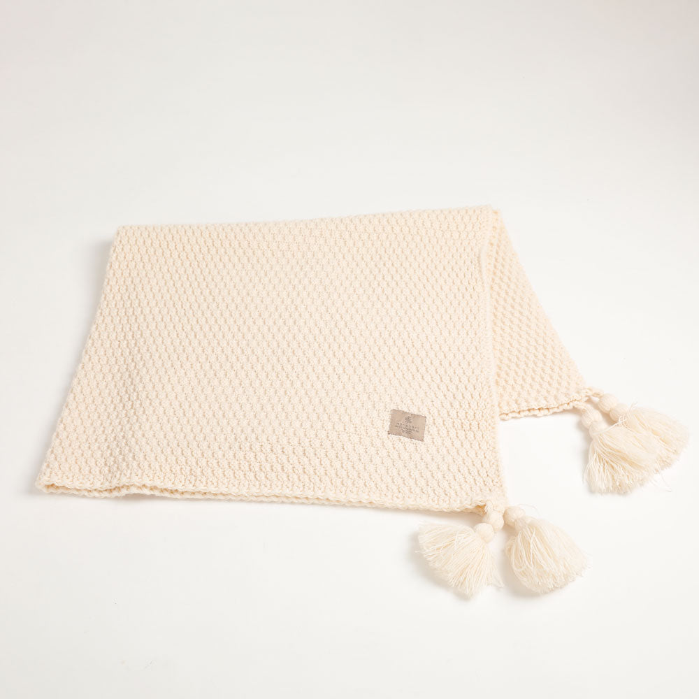 Knit blanket with tassel